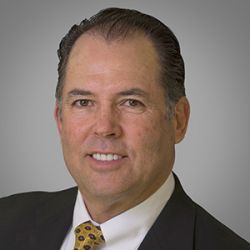 Headshot of John Etchison, smiling professionally.