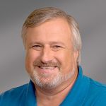 Headshot of Mark Edwards, smiling professionally.